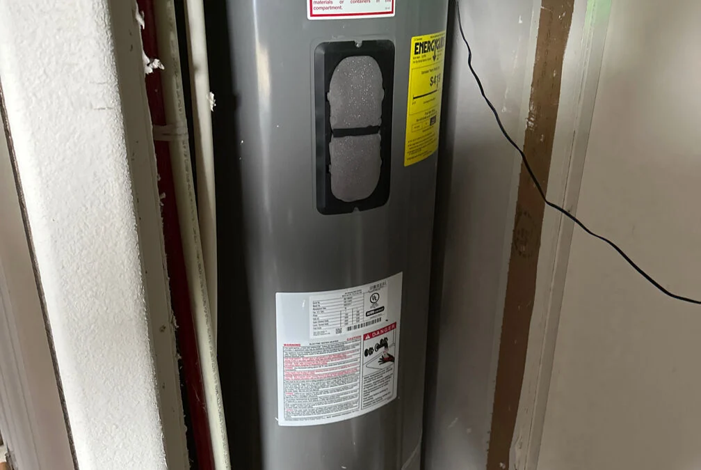 Rheem electric water heater installed in a utility closet
